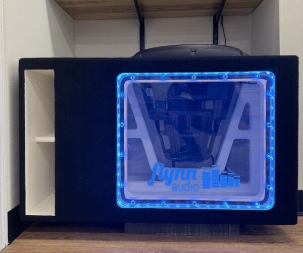Speaker with blue LED lights and Flynn Audio logo.