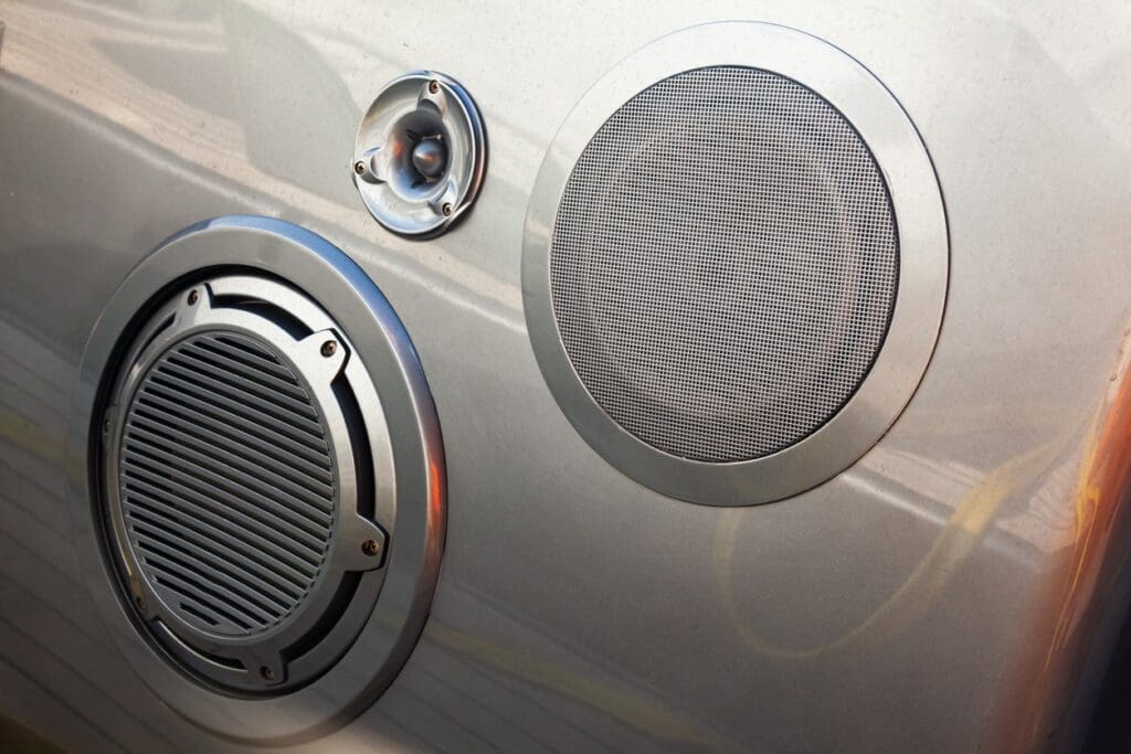 Car audio speakers on metal surface