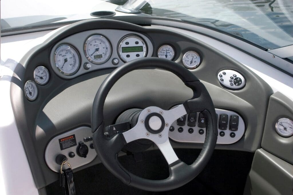 Boat dashboard with steering wheel and gauges