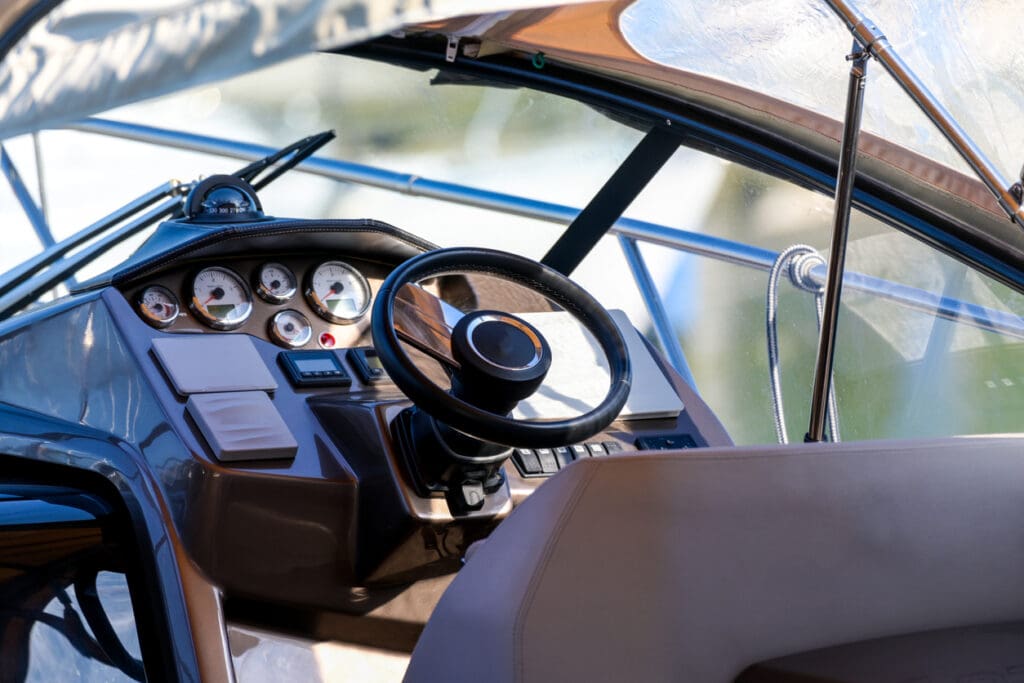 Luxury boat steering wheel and dashboard close-up.