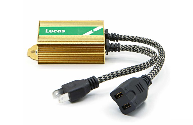 Gold electrical resistor with braided cables and plugs.
